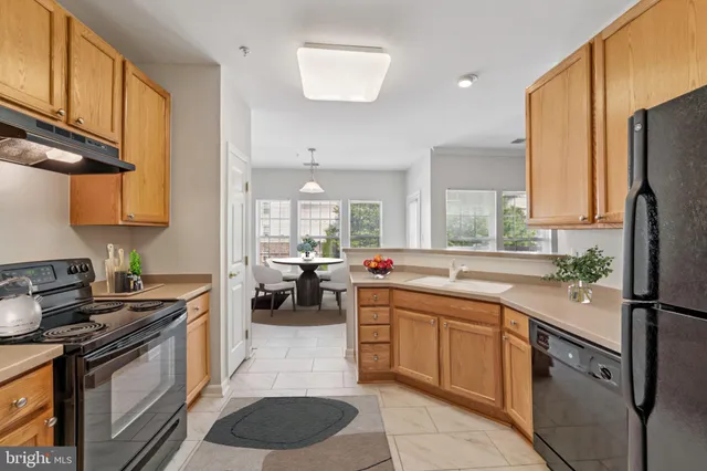 a kitchen with a sink stove and refrigerator