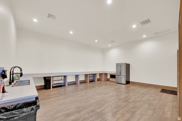 6120 North Sheps Ridge Road Eagle Mountain, UT 84005 - Photo 25 of 43 Spacious room featuring wood-finish flooring, recessed lighting, and white walls