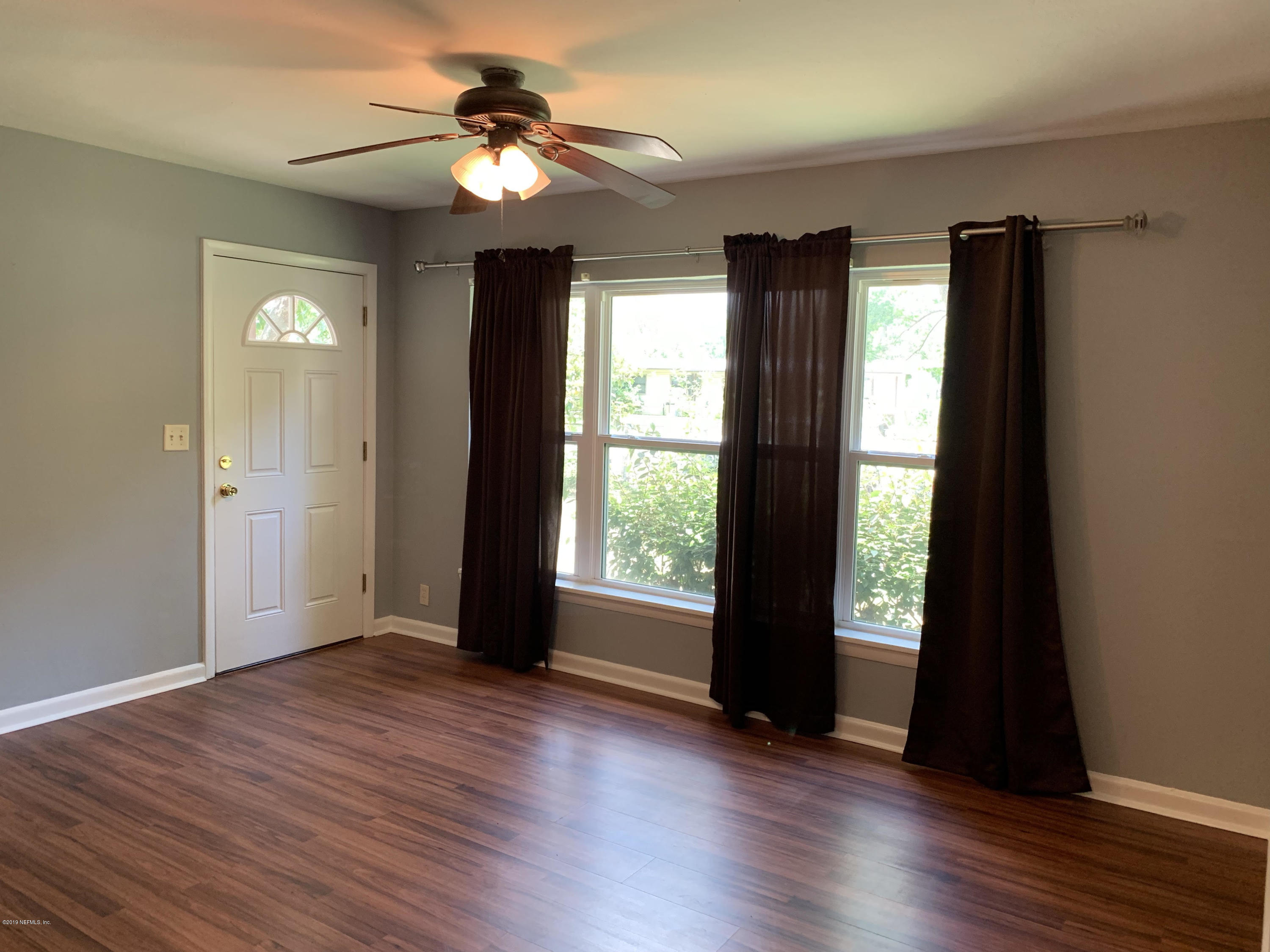 5304 Batley Road Jacksonville, FL 32210 - Photo 3 of 10 wooden floor in an empty room with a window