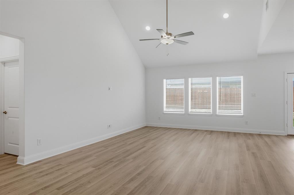 2911 Hanscom Street Forney, TX 75126 - Photo 3 of 40 Spacious interior featuring a vaulted ceiling, wood-finish flooring, recessed lighting, and a ceiling fan