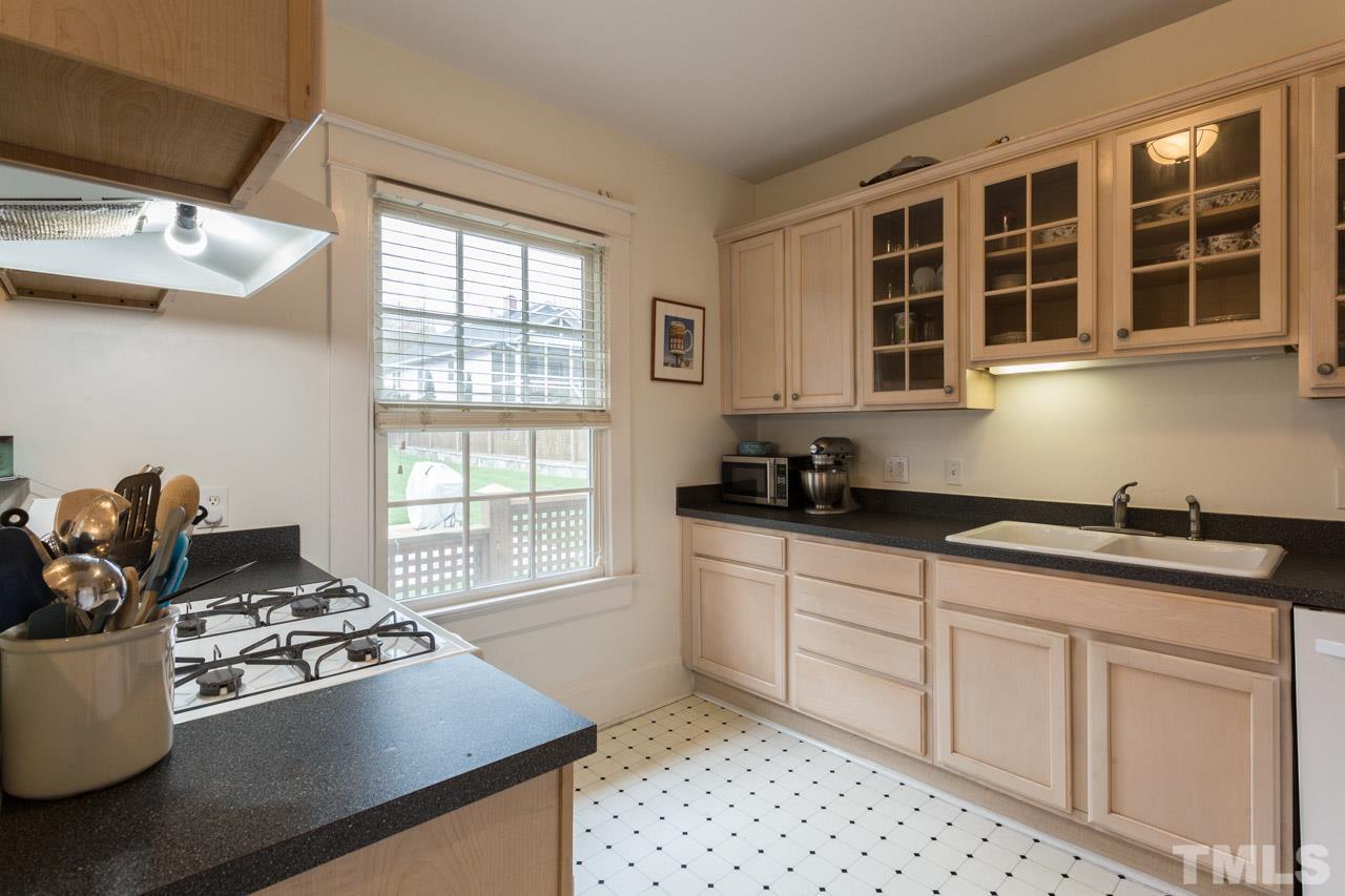 613 Elm Street Raleigh, NC 27604 - Photo 8 of 19 a kitchen with stainless steel appliances granite countertop a sink stove and cabinets