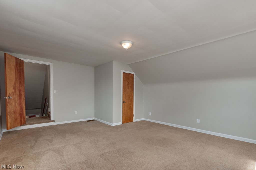 29005 Ridge Road Wickliffe, OH 44092 - Photo 18 of 31 Bedroom is freshly painted in modern neutral colors while still keeping the softness of the natural wood stained doors.