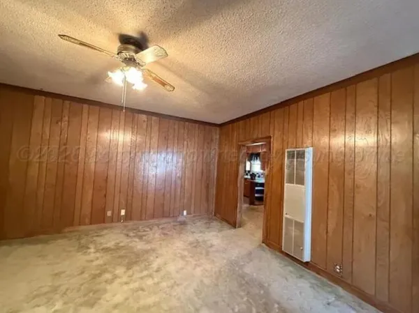a view of hallway with closet and a window