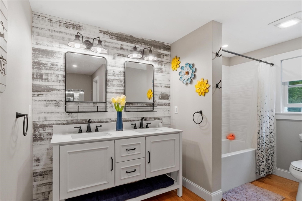 241 Reservoir Road Lunenburg, MA 01462 - Photo 29 of 40 a bathroom with a double vanity sink mirror and shower