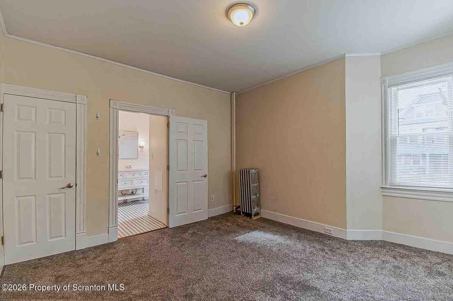 815 Monroe Avenue Scranton, PA 18510 - Photo 14 of 22 an empty room with windows and closet