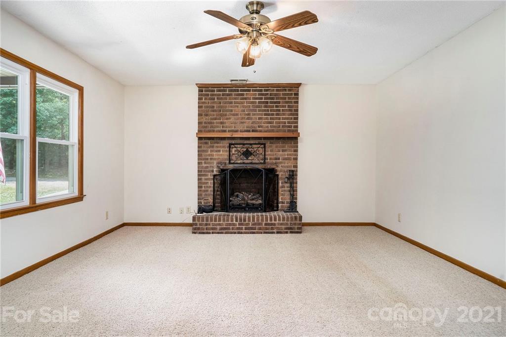 2269 Patterson Road Clover, SC 29710 - Photo 5 of 20 a view of an empty room with a fireplace and a window