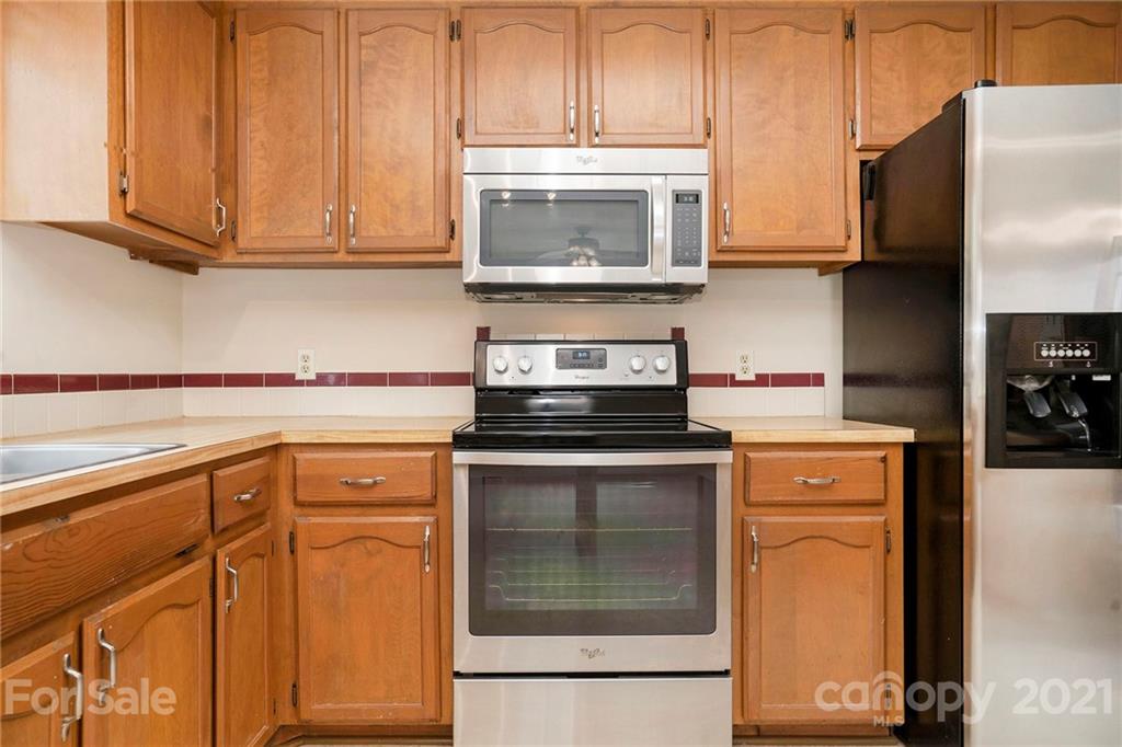 2269 Patterson Road Clover, SC 29710 - Photo 8 of 20 a kitchen with granite countertop cabinets stainless steel appliances and wooden cabinets