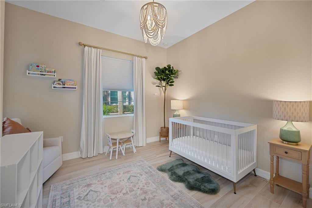 6522 Monterey Point, Unit 101 Naples, FL 34105 - Photo 12 of 29 a bedroom with furniture and a window