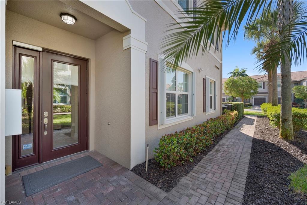 6522 Monterey Point, Unit 101 Naples, FL 34105 - Photo 2 of 29 a view of a house with a yard