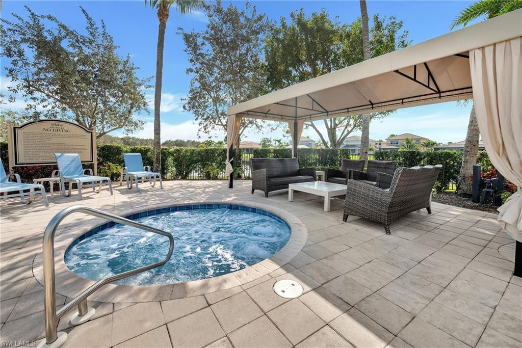 6522 Monterey Point, Unit 101 Naples, FL 34105 - Photo 21 of 29 a view of swimming pool with outdoor seating and plants