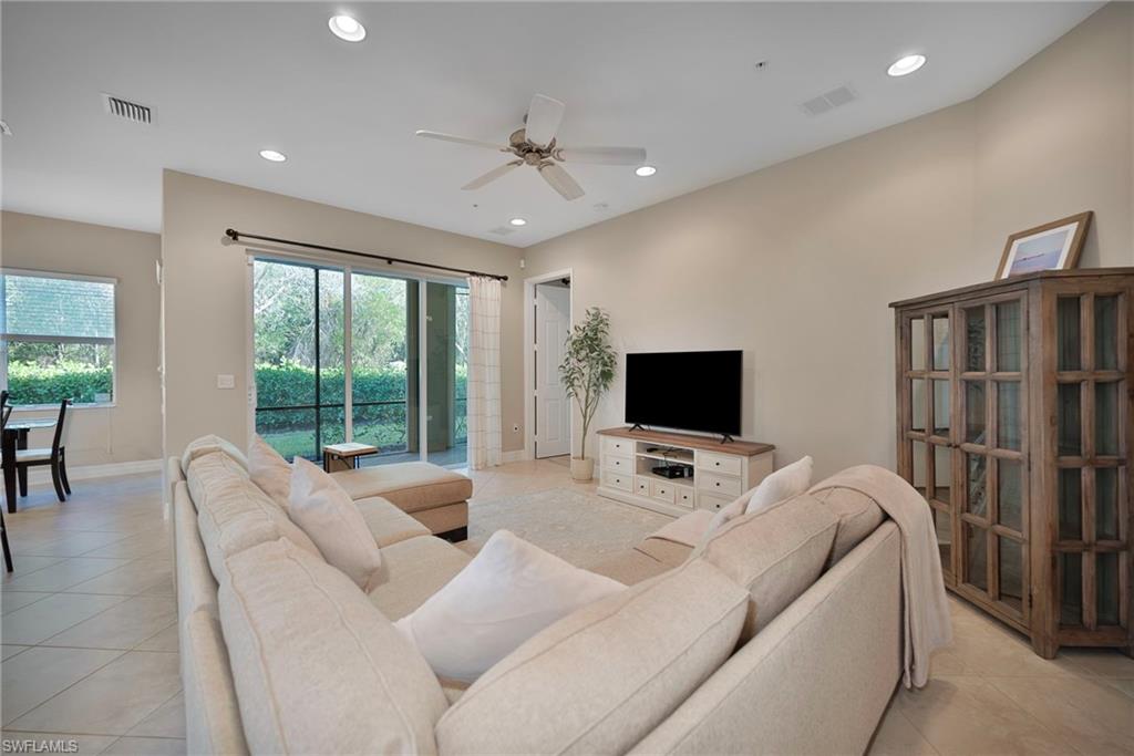 6522 Monterey Point, Unit 101 Naples, FL 34105 - Photo 3 of 29 a living room with furniture tv and a flat screen tv