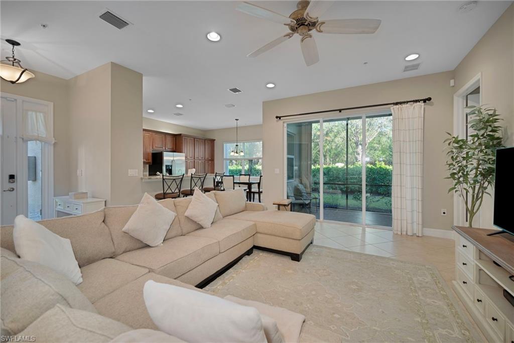 6522 Monterey Point, Unit 101 Naples, FL 34105 - Photo 29 of 29 a living room with furniture and a large window