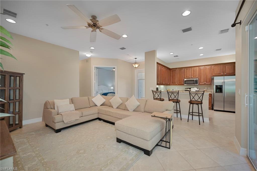 6522 Monterey Point, Unit 101 Naples, FL 34105 - Photo 4 of 29 a living room with furniture and kitchen view