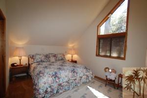 24620 Upper Rim Rock Road Idyllwild, CA 92549 - Photo 13 of 16 a bed room with a bed and a window