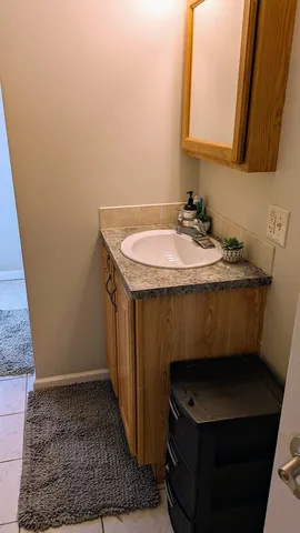 a bathroom with a sink a toilet and a mirror