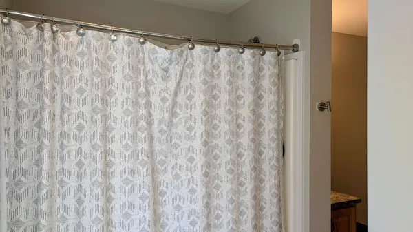a bathroom with a shower curtain and a curtain