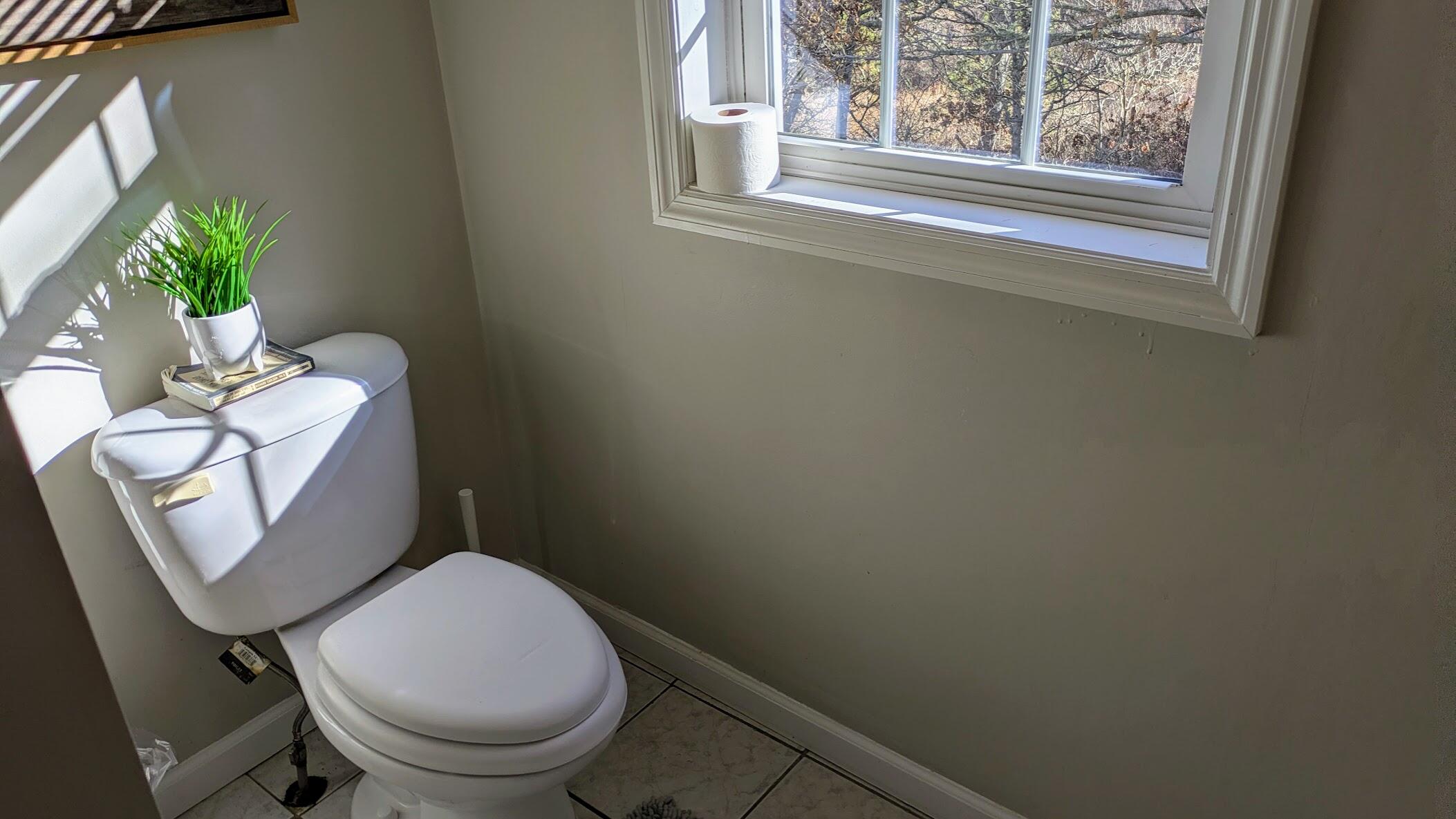 82 Old Orchard Road Eastham, MA 02642 - Photo 16 of 22 a white toilet sitting next to a window