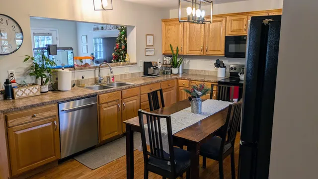 a kitchen with a table chairs refrigerator and cabinets
