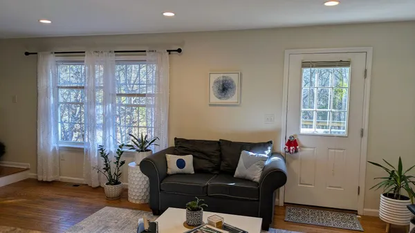 a living room with furniture and wooden floor