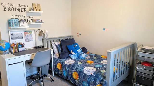 a bedroom with furniture and a book shelf