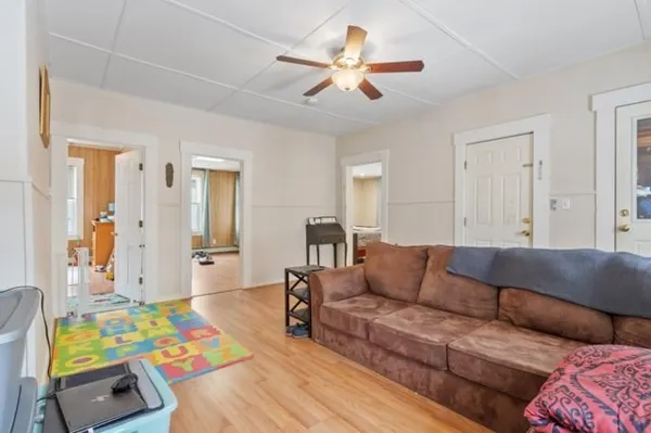 a living room with furniture and painting on the wall