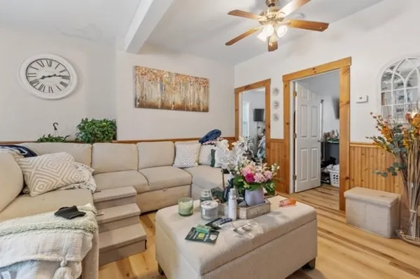 a living room with furniture potted plant and a chandelier