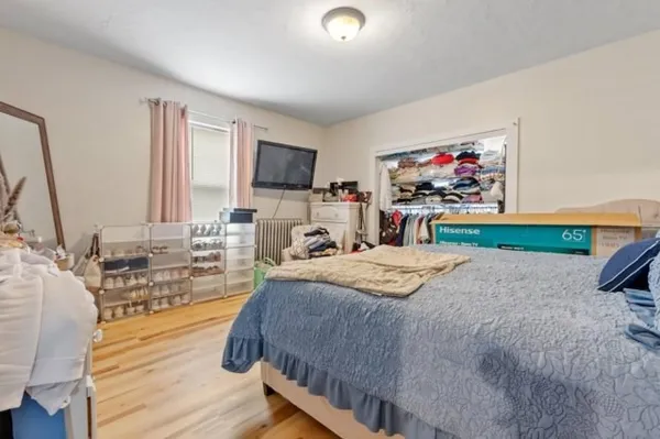 a bedroom with a bed and a flat screen tv