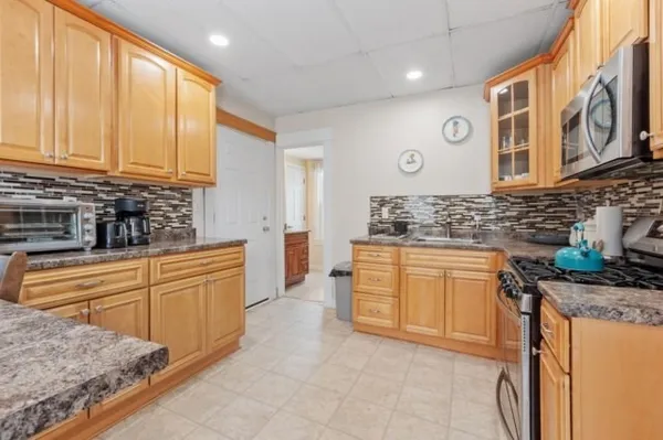 a kitchen with stainless steel appliances granite countertop a sink and cabinets