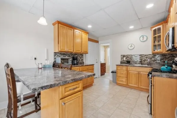 a kitchen with stainless steel appliances granite countertop a sink stove and cabinets