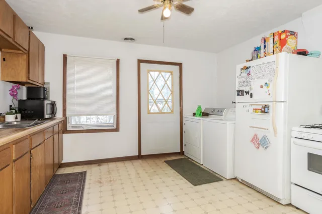 a room with a refrigerator and cabinets