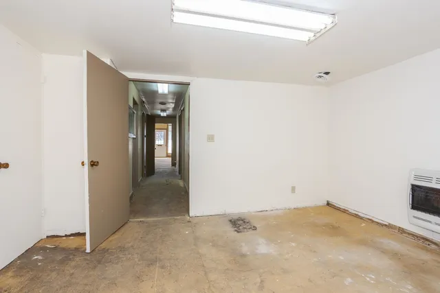 a bedroom with a bed and a mirror