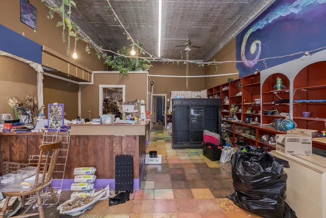 a living room with lots of furniture and a book shelf