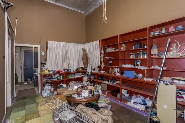 a view of a storage room with racks on the wall