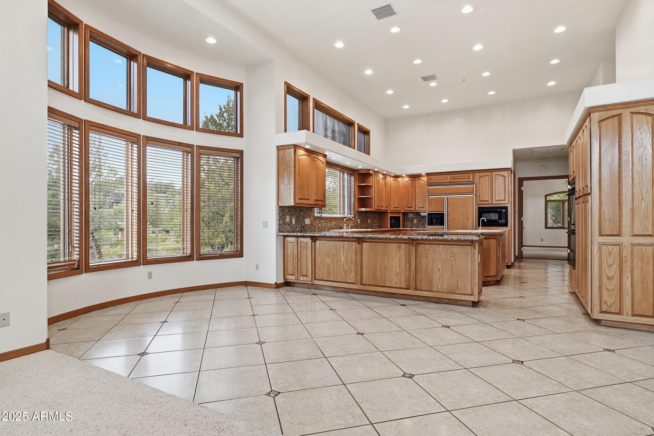 1606 Becky Circle Payson, AZ 85541 - Photo 19 of 58 a kitchen with stainless steel appliances granite countertop a refrigerator and a stove top oven