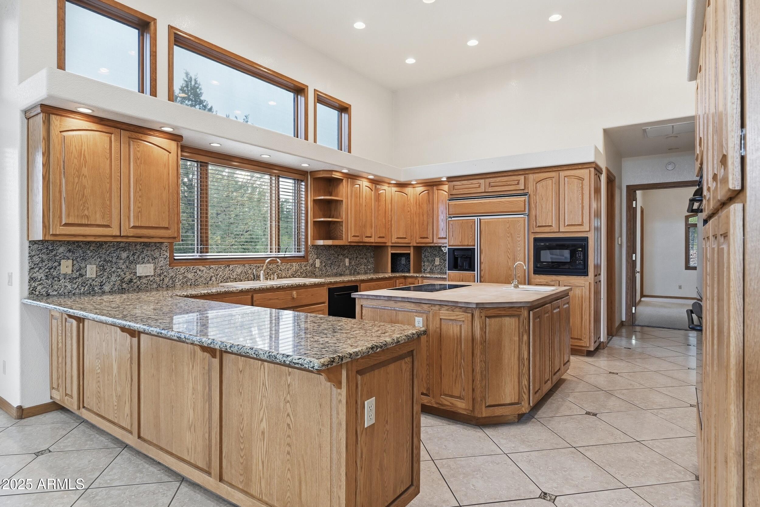 1606 Becky Circle Payson, AZ 85541 - Photo 20 of 58 a kitchen with kitchen island granite countertop a stove and a sink