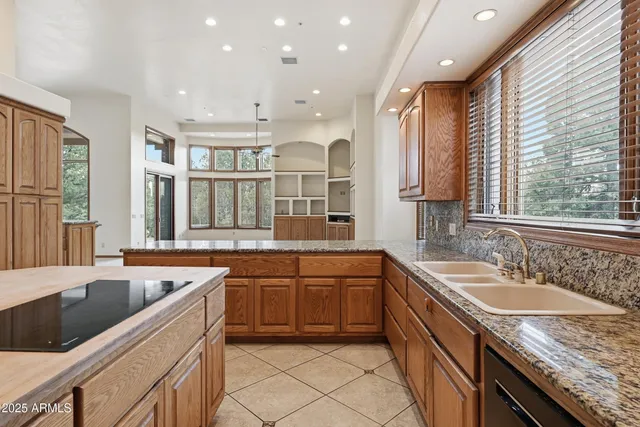 a kitchen with a sink stove and cabinets