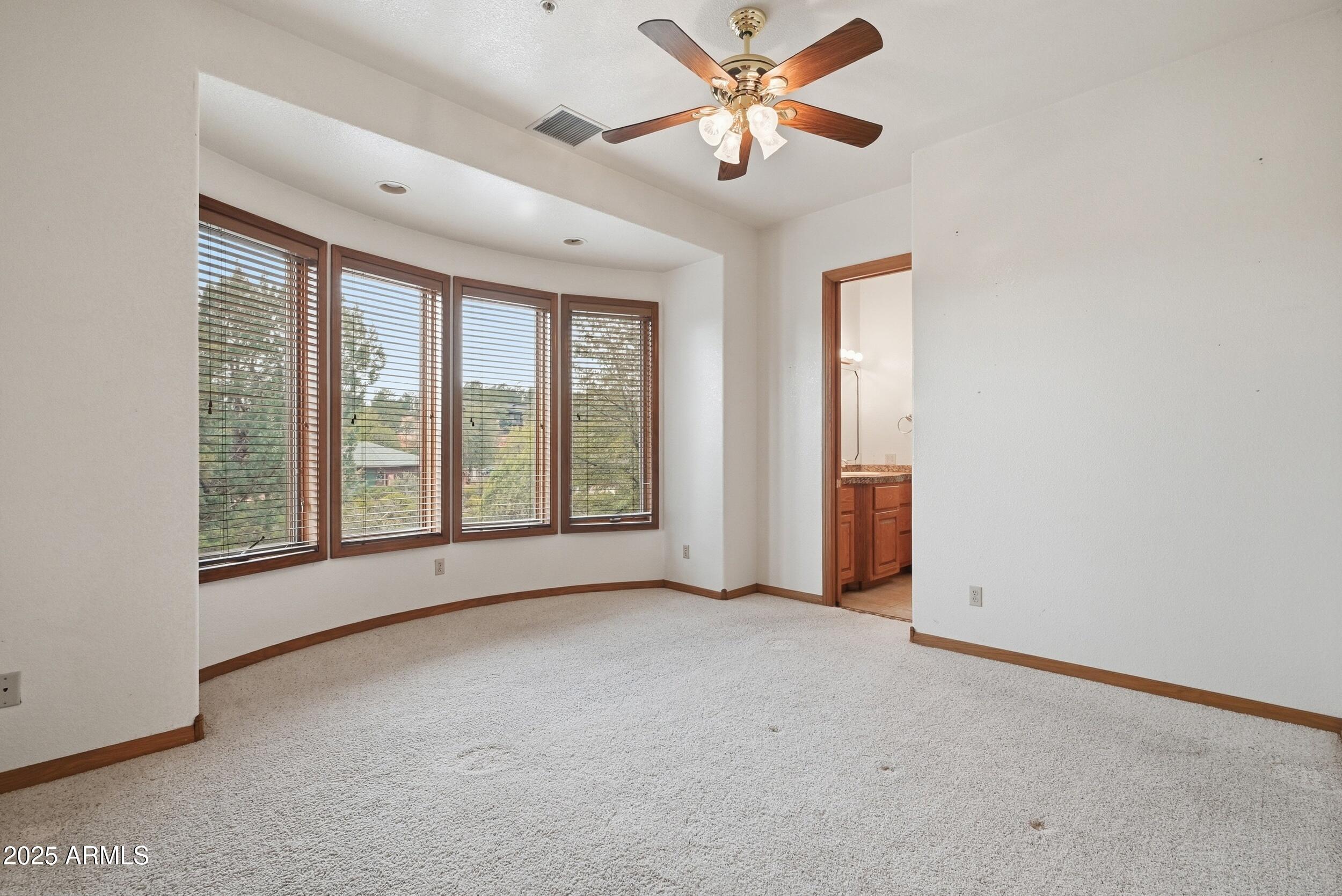 1606 Becky Circle Payson, AZ 85541 - Photo 30 of 58 an empty room with chandelier fan and windows