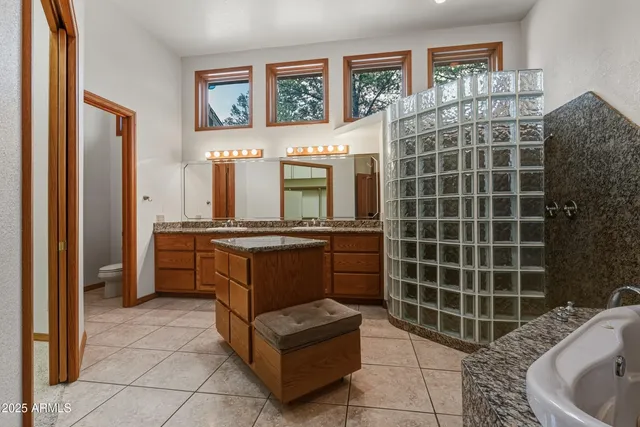 a front view of a house with a yard and tree s