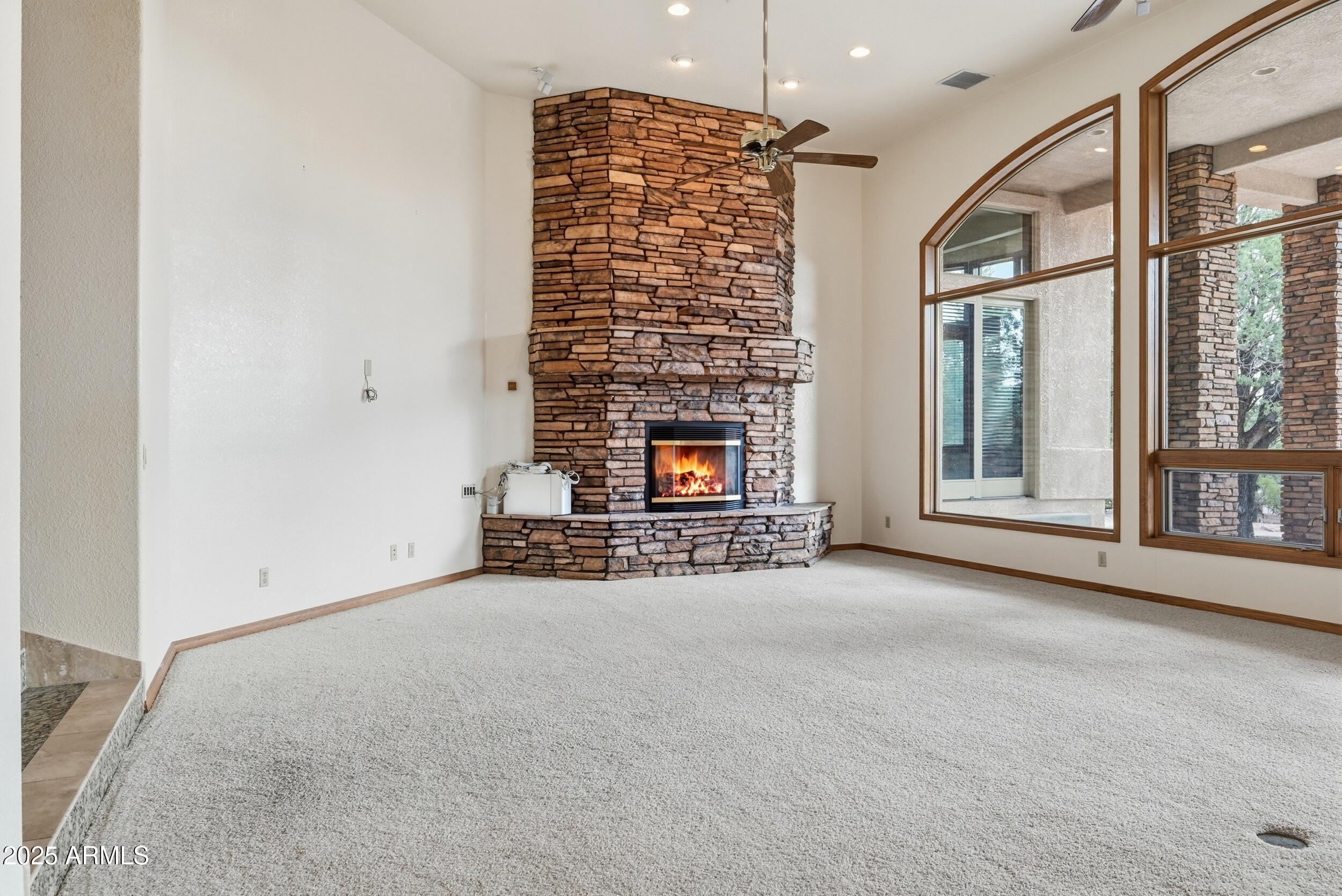 1606 Becky Circle Payson, AZ 85541 - Photo 9 of 58 a view of an empty room with a fireplace and a window