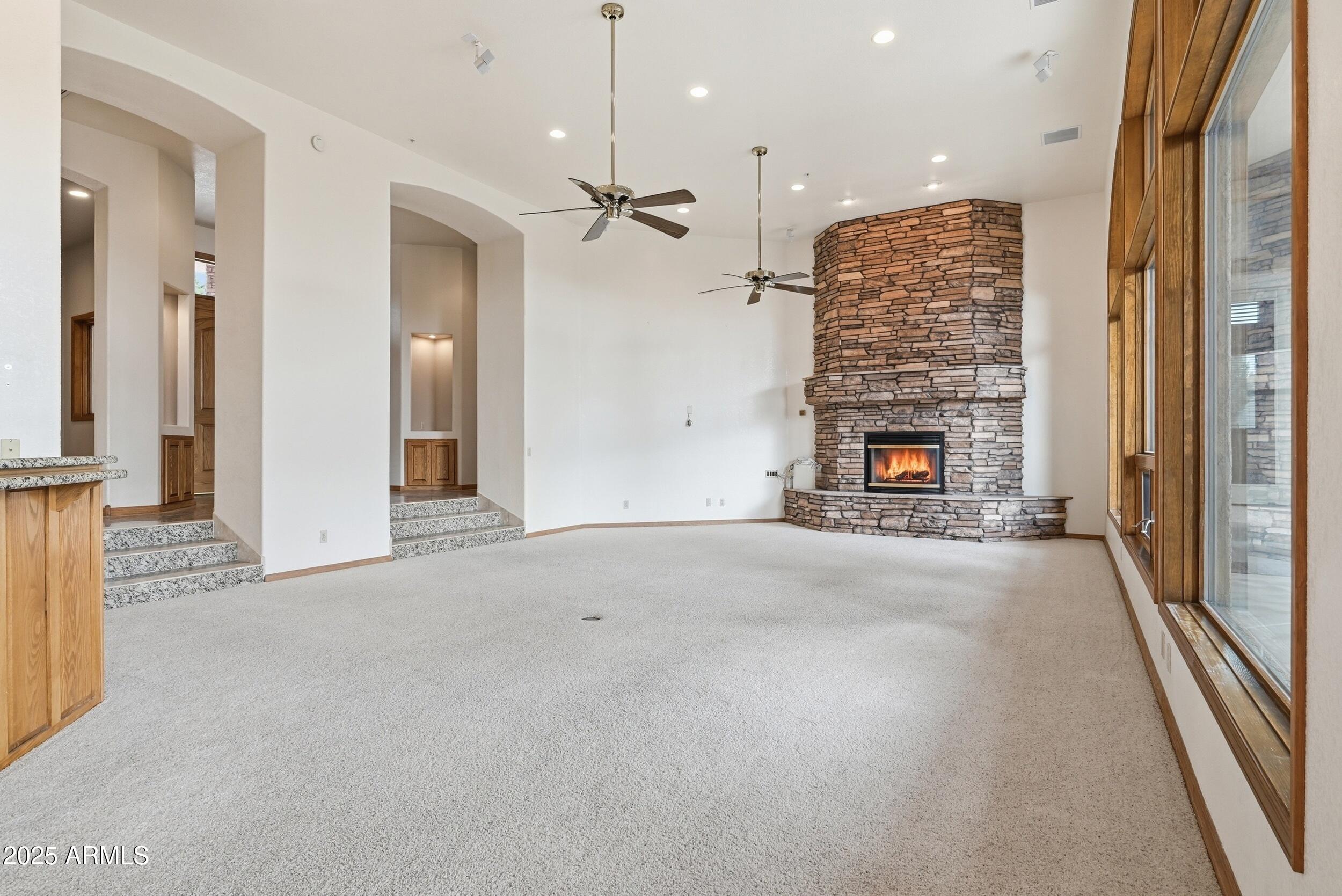 1606 Becky Circle Payson, AZ 85541 - Photo 10 of 58 an empty room with fireplace and windows