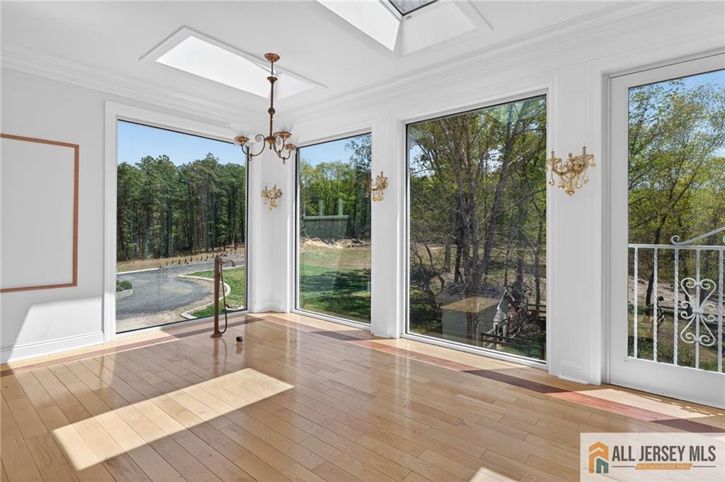 381 Monmouth Road Freehold, NJ 07728 - Photo 21 of 63 a living room with hardwood floor and a table