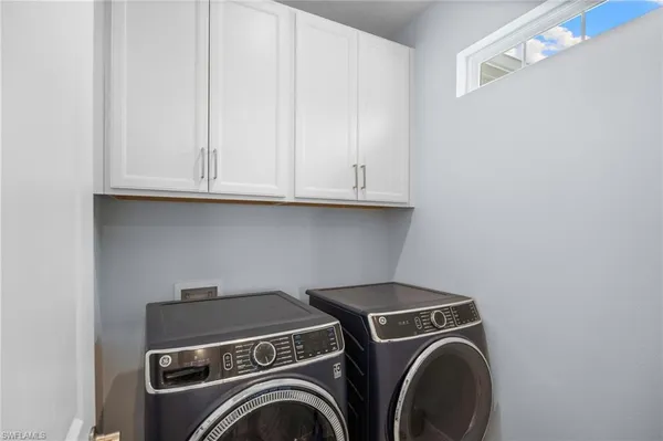 an aerial view of residential houses with outdoor space and ocean view