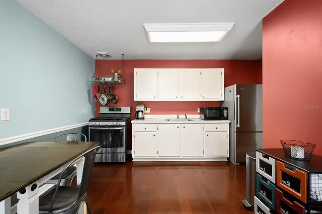 a kitchen with stainless steel appliances a stove and a refrigerator