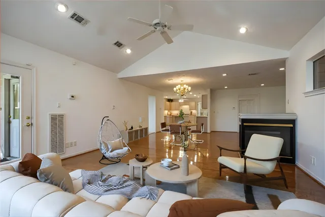 a living room with furniture and a chandelier