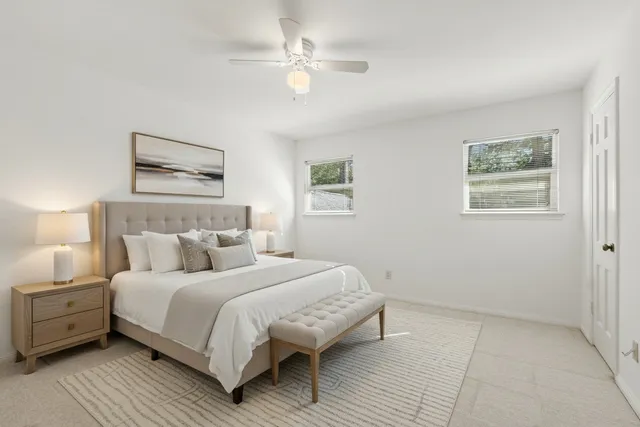 a bedroom with a bed and a painting on the wall