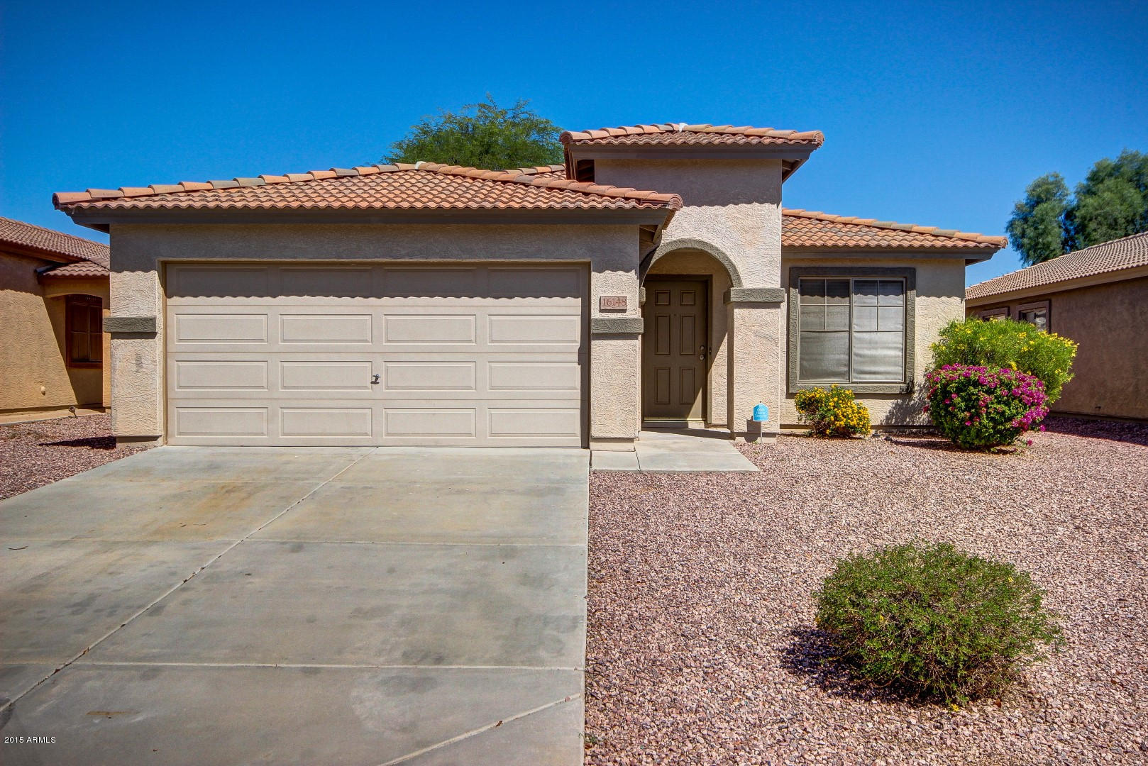 16148 West Boca Raton Road Surprise, AZ 85379 - Photo 1 of 24 a front view of a house with a yard