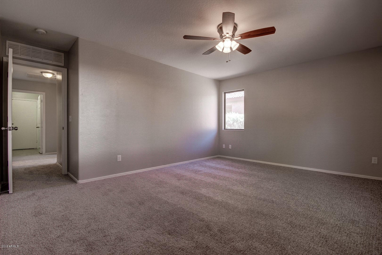 16148 West Boca Raton Road Surprise, AZ 85379 - Photo 13 of 24 an empty room that has a window and a fan