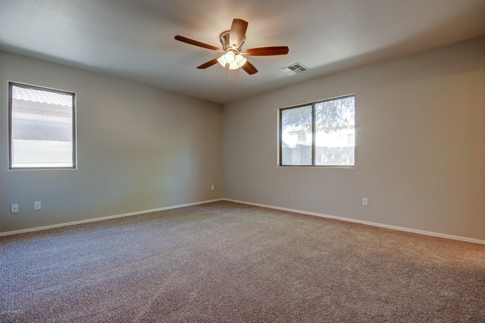 16148 West Boca Raton Road Surprise, AZ 85379 - Photo 14 of 24 an empty room with windows and ceiling fan