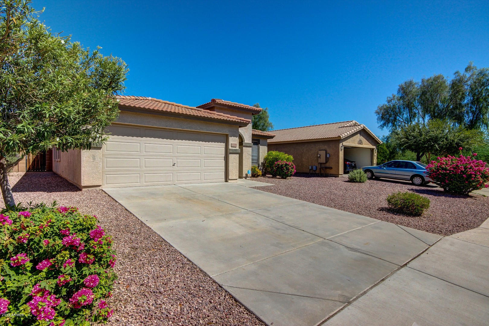 16148 West Boca Raton Road Surprise, AZ 85379 - Photo 2 of 24 a house view with a garden space