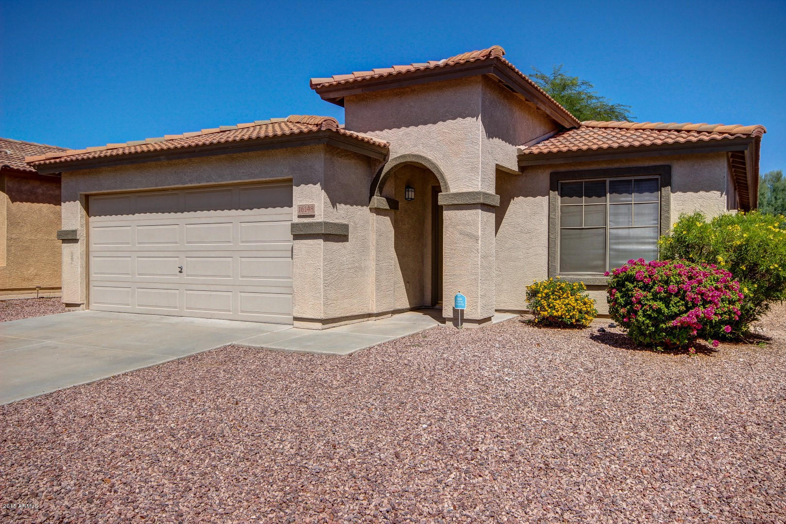 16148 West Boca Raton Road Surprise, AZ 85379 - Photo 24 of 24 a front view of a house with a yard